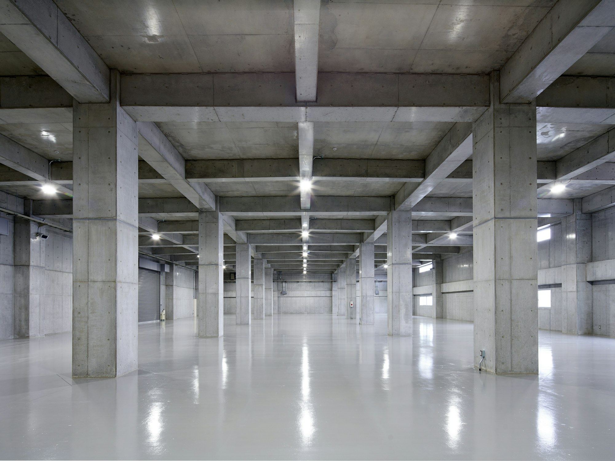 Bright, empty parking garage with glossy epoxy floor coating.